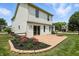 Landscaped backyard features a brick patio, fire pit, lush green lawn, and a charming wooden fence at 8835 Harrison Pkwy, Fishers, IN 46038