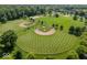 Aerial view features baseball fields and a playground surrounded by mature trees and green space at 8835 Harrison Pkwy, Fishers, IN 46038