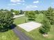 Aerial shot showcases a neighborhood basketball court surrounded by lush greenery and mature trees at 8835 Harrison Pkwy, Fishers, IN 46038