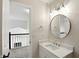 Upstairs bathroom with modern fixtures, white vanity, and view of the stairwell at 8835 Harrison Pkwy, Fishers, IN 46038