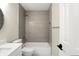 Modern bathroom featuring a tiled shower-over-tub, white fixtures, and neutral tones at 8835 Harrison Pkwy, Fishers, IN 46038