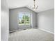 Spacious bedroom with vaulted ceilings, carpet, and a modern chandelier at 8835 Harrison Pkwy, Fishers, IN 46038