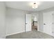 Neutral bedroom featuring carpet floors, with a view of the stairwell at 8835 Harrison Pkwy, Fishers, IN 46038