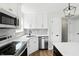 Well-appointed kitchen with stainless steel appliances, modern faucet, quartz counters, and white cabinets at 8835 Harrison Pkwy, Fishers, IN 46038