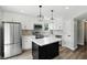 Bright kitchen features white cabinets, stainless steel appliances, a center island, and modern pendant lighting at 8835 Harrison Pkwy, Fishers, IN 46038