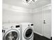 Functional laundry room with modern washer and dryer, black tile flooring, and access to the exterior at 8835 Harrison Pkwy, Fishers, IN 46038