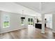Open concept living room features hardwood floors, sliding glass doors, and pendant lighting at 8835 Harrison Pkwy, Fishers, IN 46038