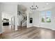 Open-concept living room featuring hardwood floors, staircase, and lots of natural light at 8835 Harrison Pkwy, Fishers, IN 46038