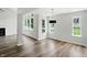 Open living space with hardwood floors, fireplace and large windows at 8835 Harrison Pkwy, Fishers, IN 46038