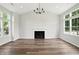 Spacious living room featuring a fireplace, high ceilings, hardwood floors, and large windows at 8835 Harrison Pkwy, Fishers, IN 46038