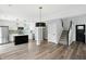 Open-concept kitchen and living area with hardwood floors and stainless steel appliances at 8835 Harrison Pkwy, Fishers, IN 46038