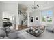 Staged living room showcasing the open floor plan, hardwood floors, and modern decor at 8835 Harrison Pkwy, Fishers, IN 46038