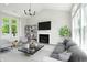 Staged living room showcasing a fireplace, hardwood floors, and stylish furniture at 8835 Harrison Pkwy, Fishers, IN 46038