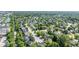 Aerial view showcasing residential area nestled among trees and a nearby pond, complemented by commercial spaces at 8835 Harrison Pkwy, Fishers, IN 46038