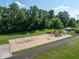 Aerial view features a colorful playground with swings and slides near a paved walking path at 8835 Harrison Pkwy, Fishers, IN 46038