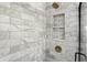 Shower features tiled walls, bronze fixtures, and a convenient built-in shelf at 8835 Harrison Pkwy, Fishers, IN 46038