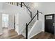 Staircase features white railings with black accents, carpeted steps, and wood flooring at 8835 Harrison Pkwy, Fishers, IN 46038