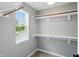 Well-organized walk-in closet with window, multiple rods, and shelving at 8835 Harrison Pkwy, Fishers, IN 46038
