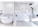 Modern bathroom featuring a sleek soaking tub and frameless glass shower with marble tile at 886 J Mccool Way, Greenwood, IN 46142