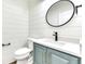 Stylish powder room featuring shiplap walls, a sleek black faucet, oval mirror and a marble countertop at 886 J Mccool Way, Greenwood, IN 46142