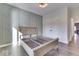 Bedroom featuring gray wainscoting, a window, and hardwood floors, offering a serene retreat at 886 J Mccool Way, Greenwood, IN 46142