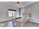 This bedroom boasts stylish wainscoting, a large window, and beautiful hardwood floors at 886 J Mccool Way, Greenwood, IN 46142