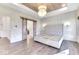 Light-filled bedroom with wood-look ceiling, wainscotting, and barn doors leading to the ensuite bathroom at 886 J Mccool Way, Greenwood, IN 46142