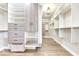 Walk-in closet with custom white shelving, drawers, and hardwood floors at 886 J Mccool Way, Greenwood, IN 46142