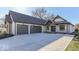 Lovely home exterior featuring an attached garage, spacious driveway, and manicured landscaping at 886 J Mccool Way, Greenwood, IN 46142