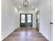 Bright foyer with hardwood floors, double doors, and paneled walls at 886 J Mccool Way, Greenwood, IN 46142