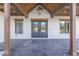 Inviting front porch with stone flooring, wooden posts, and double front doors at 886 J Mccool Way, Greenwood, IN 46142