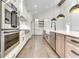 Stylish kitchen featuring white cabinets, modern stainless steel appliances, and beautiful wood floors at 886 J Mccool Way, Greenwood, IN 46142