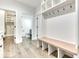Spacious mudroom with built-in bench and coat rack, with easy access to the powder room and walk-in closet at 886 J Mccool Way, Greenwood, IN 46142