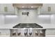 Close-up of a modern range with a stainless steel hood and quartz countertops at 886 J Mccool Way, Greenwood, IN 46142