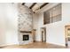 A modern living room featuring a stone fireplace, high ceilings and hardwood floors at 10201 - Lot 2 N Alford Rd, Fortville, IN 46040