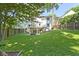 Large backyard with lush grass, a wood fence, and a patio, offering privacy and space for recreation at 111 N 8Th St, Zionsville, IN 46077