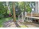 Beautiful backyard with mature trees, a wood deck, and a play area for outdoor enjoyment and recreation at 111 N 8Th St, Zionsville, IN 46077