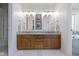 Bathroom featuring double sinks, granite countertops, and wood cabinetry, combining style and functionality at 111 N 8Th St, Zionsville, IN 46077