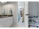 A bathroom showing the vanity, toilet, and a view into an adjacent room with a shower at 111 N 8Th St, Zionsville, IN 46077