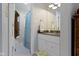 The well-lit bathroom has a white vanity, towel rack, and a view into the toilet and shower space at 111 N 8Th St, Zionsville, IN 46077