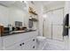 Well-lit bathroom features a framed glass shower, vanity with granite countertop, and modern fixtures at 111 N 8Th St, Zionsville, IN 46077