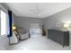 Bright Bedroom with neutral tones, a crib, dresser, and ample natural light, creating a serene atmosphere at 111 N 8Th St, Zionsville, IN 46077