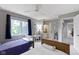 This bedroom has twin beds, a desk with chair, and natural light from a window with blue curtains at 111 N 8Th St, Zionsville, IN 46077