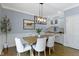 Beautiful dining room with overhead lighting, views, seating for four and wainscoting at 111 N 8Th St, Zionsville, IN 46077