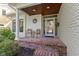 Charming brick porch with seating area, adding to the home's curb appeal at 111 N 8Th St, Zionsville, IN 46077