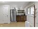Kitchenette features stainless steel refrigerator, dark cabinetry, and shelving at 111 N 8Th St, Zionsville, IN 46077