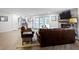 Open living room with a brick fireplace and access to the backyard through sliding doors at 111 N 8Th St, Zionsville, IN 46077