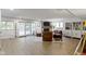 Basement living room with brick fireplace, wood-look flooring, and sliding glass doors at 111 N 8Th St, Zionsville, IN 46077