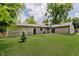 Enjoy the spacious backyard, surrounded by mature trees, and a view of the sliding glass door at 11230 N College Ave, Carmel, IN 46032
