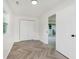 Bedroom with luxury vinyl plank flooring, double closets and a double set of windows, offering ample storage at 11230 N College Ave, Carmel, IN 46032